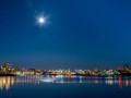 The bright moon bursts upon the Inner Harbour of Victoria, BC on a calm winter's night.